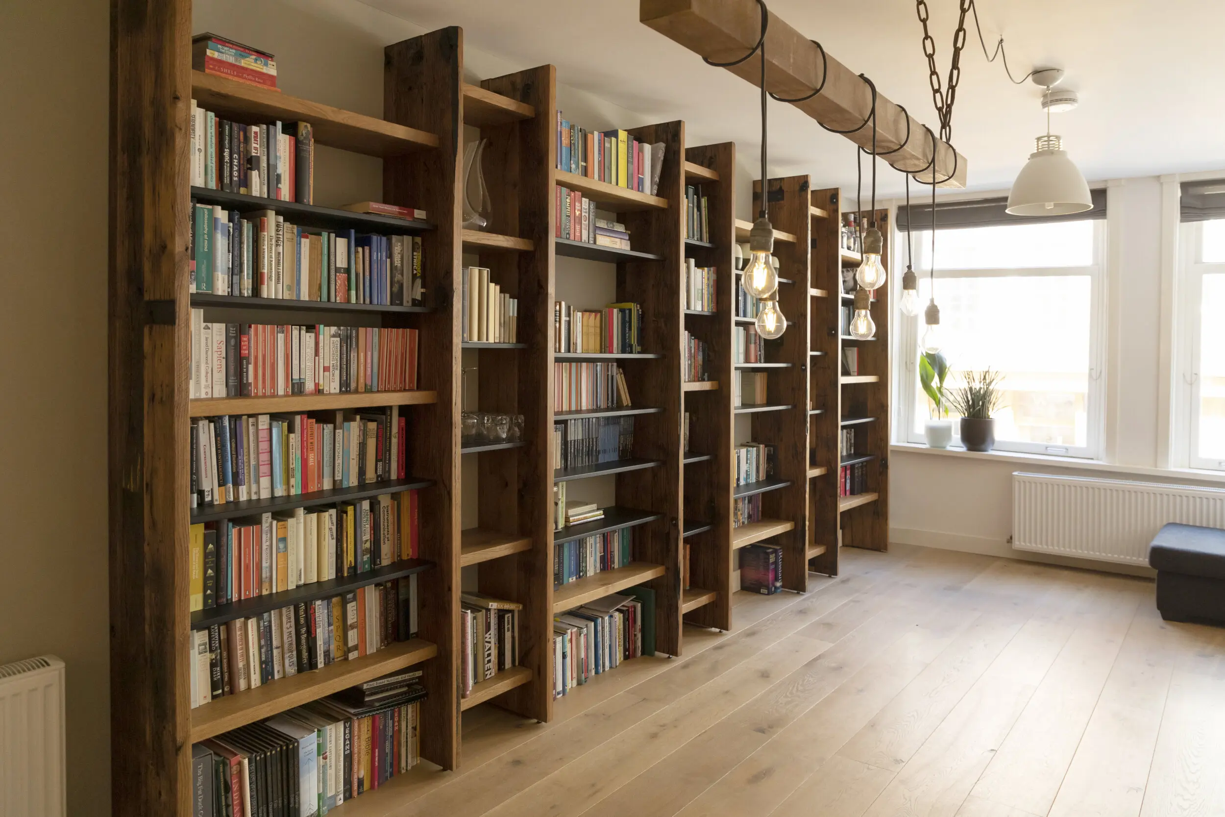 Bespoke Reclaimed oak bookshelves. With books on them. Carpenter Amsterdam