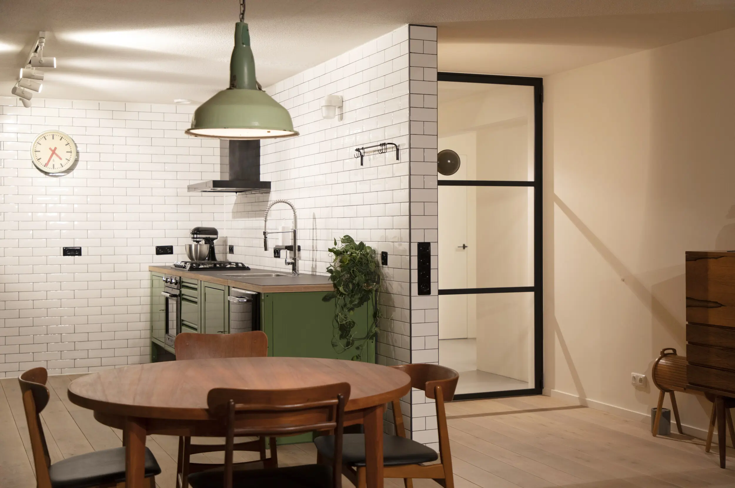 Industrial door, metro tiles. Open plan living room kitchen.