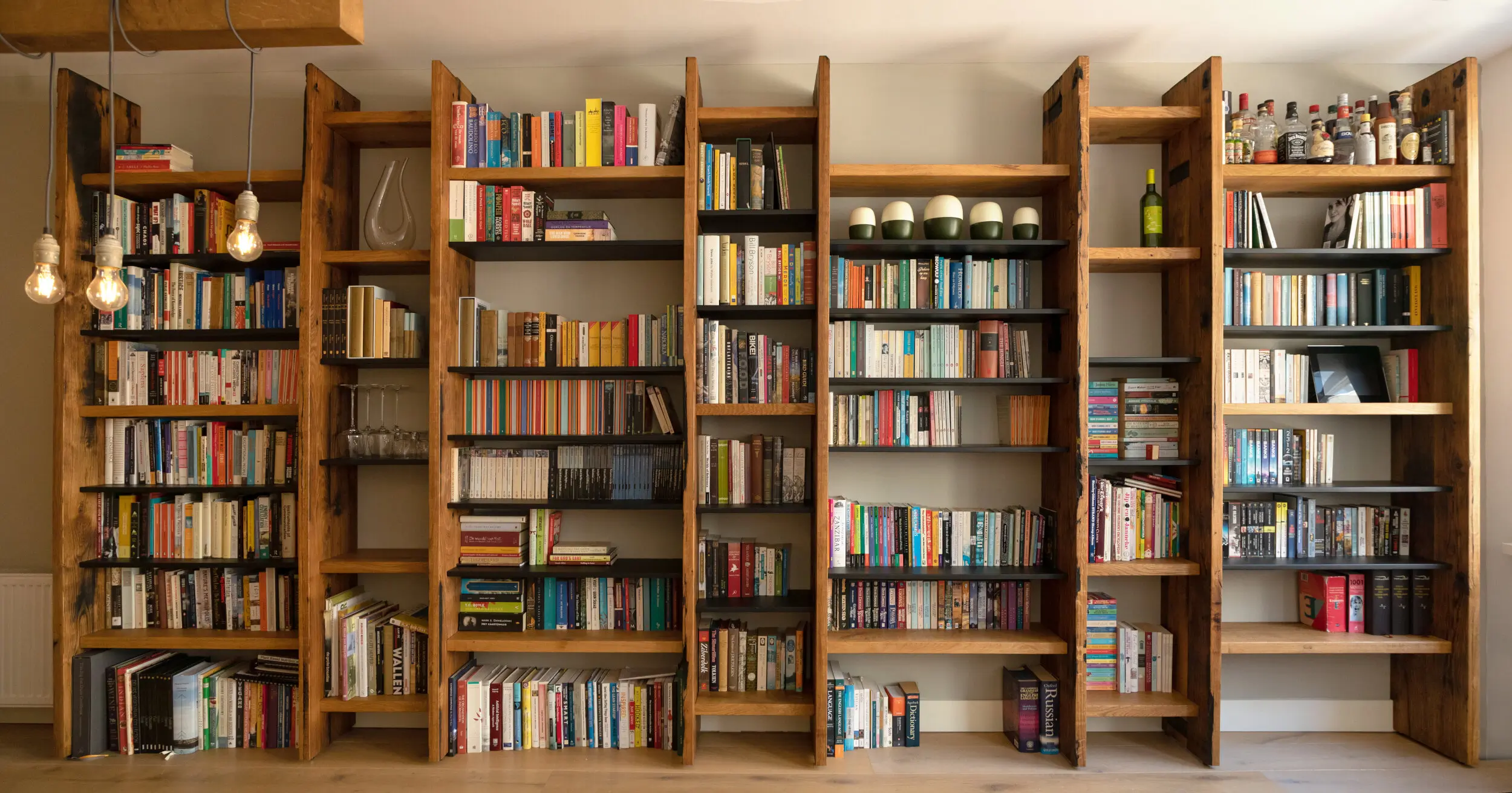Bespoke Reclaimed oak bookshelves. With books on them. Carpenter Amsterdam